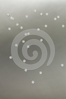White snowflakes on a silver background