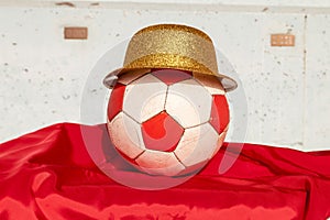 White soccer ball with red pentagons on a red flag