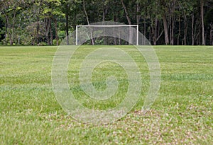 White soccer goal seen from midfield