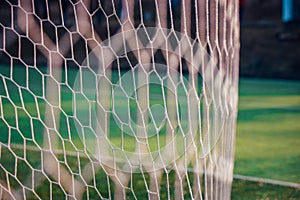 White soccer net, green grass in background, football background photo