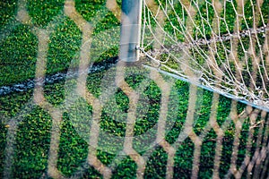 White soccer net, green grass in background, football background photo