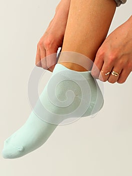 white sock with copy space on human foot closeup photo on white background