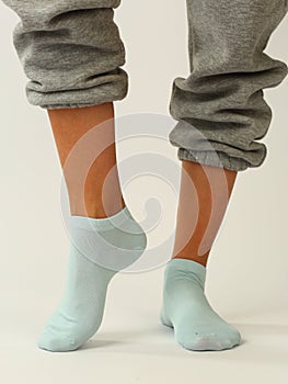 white sock with copy space on human foot closeup photo on white background