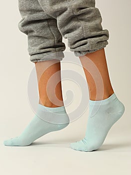 white sock with copy space on human foot closeup photo on white background