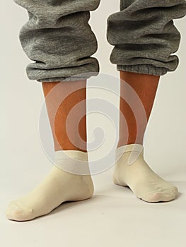 white sock with copy space on human foot closeup photo on white background