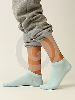 white sock with copy space on human foot closeup photo on white background