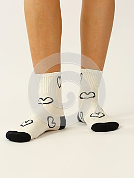 white sock with copy space on human foot closeup photo on white background