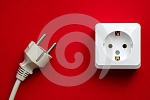 white socket and black plug  on red background