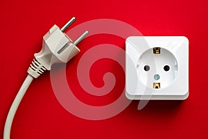 white socket and black plug  on red background