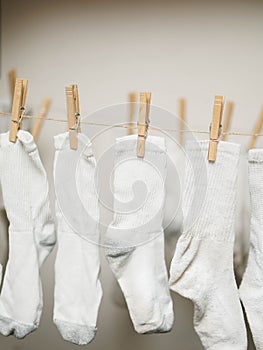 White socks clipped to rope to dry