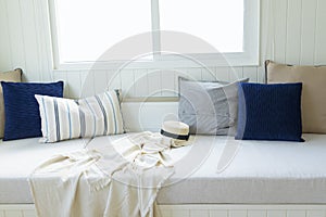 White sofa bed nook with comfortable pillows and blanket