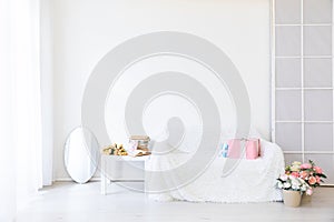 white sofa with gifts coffee table with flowers in bright interior room