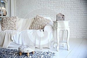 White sofa and nightstand with changeover calendar in a stylish living room