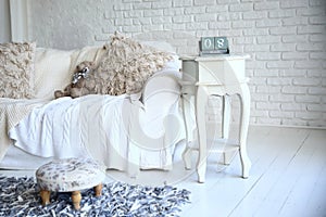 White sofa and nightstand with changeover calendar in a stylish living room