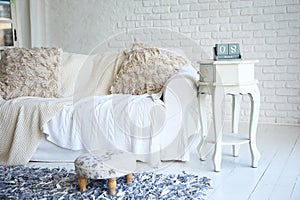 White sofa and nightstand with changeover calendar in a stylish living room