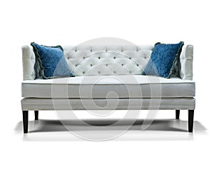 White sofa with two blue pillows