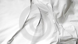 White soft bed linen with a clean duvet, creating a cozy background.