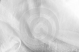 White soft cloth surface as background. Abstract white texture