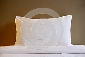 White soft pillow and bed sheet in room at the hotel resort.