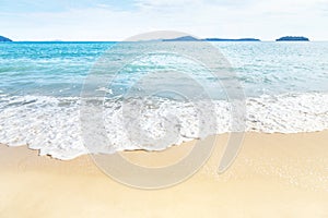 White soft wave rolling splash on empty tropical sandy beach