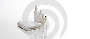 white spa towel and jars with bottles of body care