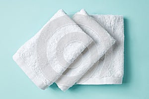 White spa towels on blue, from above