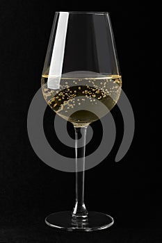 White sparkling wine glass on black background