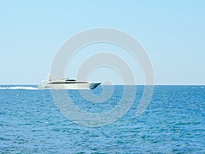 White speed yatch in open waters full ahead