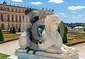 White Sphinx statue and Cupid bronze statue in the Versailles Gardens