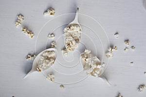 White spoon with popcorn. photo