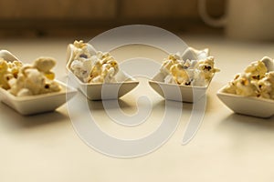 White spoon with popcorn. photo