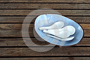 White spoons in blue plate