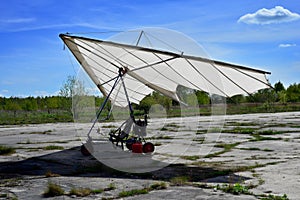 White sport hang glider on an old aerofield