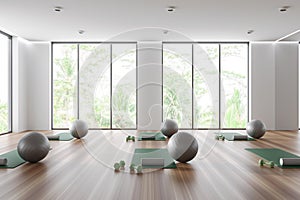 White sport interior with yoga equipment and panoramic window