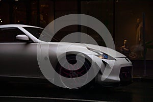 White sports car with pink rims