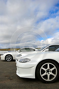 White sports cars at racetrack