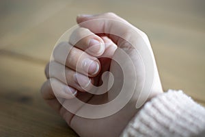 White spot on the womans fingernail, called leukonychia