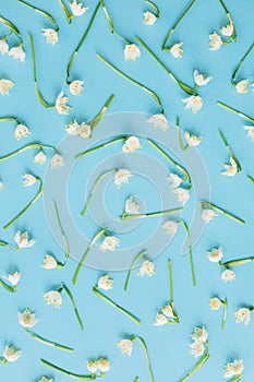 White spring flowers on blue flat lay. Floral trendy pattern. Hello spring. Stylish greeting card. Happy womens day concept. Happy