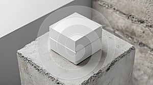 White Square Box on a Concrete Cube Platform Against Concrete Background