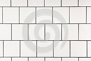 White square ceramic tile with black seam, located horizontally. Abstract background, ceramic texture. photo