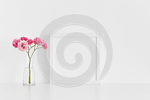 White square frame mockup with pink roses in a glass vase on a white table