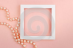 White square frame with pearl beads on a pink pearl design board