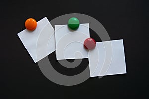 White square note stickers on a black Board.