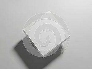 A white square object casting a shadow on a gray background surface