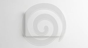 A white square object on a white surface