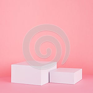 White square podiums for display cosmetic and goods on gentle pastel pink spring background, modern fashion style.