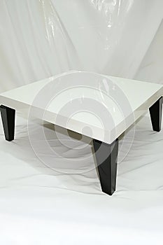 White square table with black legs