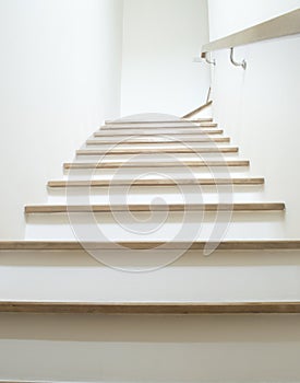 white Stairs on wood and white wall with wood handrail