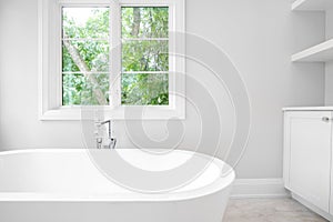 A white standalone tub in a luxury bathroom.