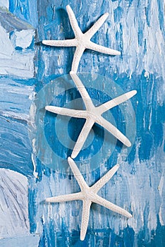 White starfish on blue painted background